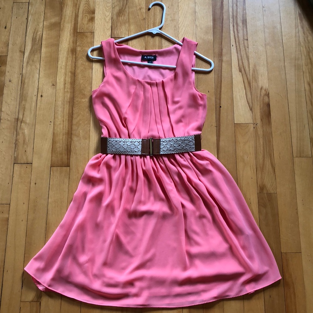 Peach colored dress with light brown leather belt.